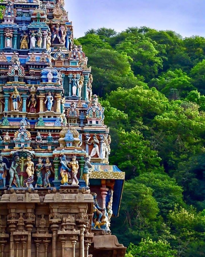 The enchanting Alagar Koyil Temple with lush green mountain backdrop the temple …